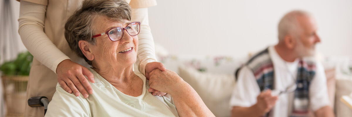 A carer holding the hand of an older person in support